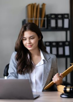 Asian lawyer woman working with a laptop computer in a law office. Legal and legal service concept.